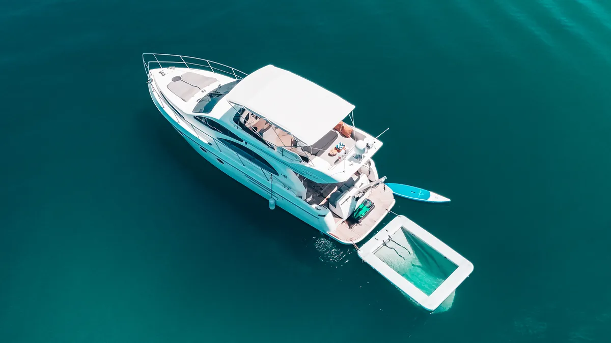Azimut 46 Aqua Mas — overhead aerial view with the swim platform and water toys deployed