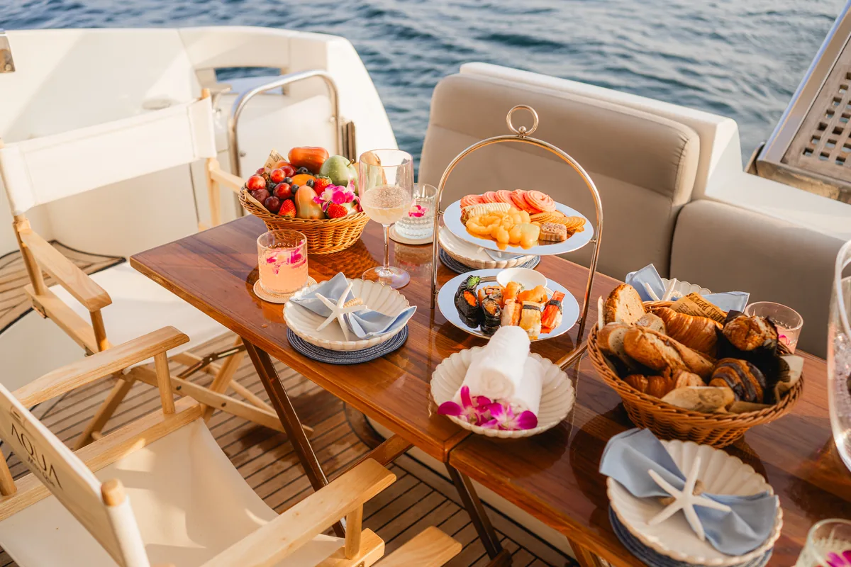 Azimut 46 Aqua Mas — alfresco table set with fresh fruit and pastries