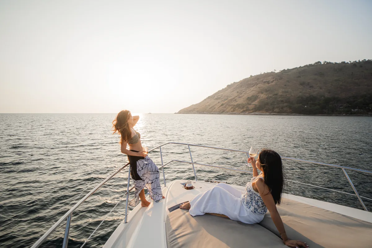 Azimut 46 Aqua Mas — guests on the bow at sunset