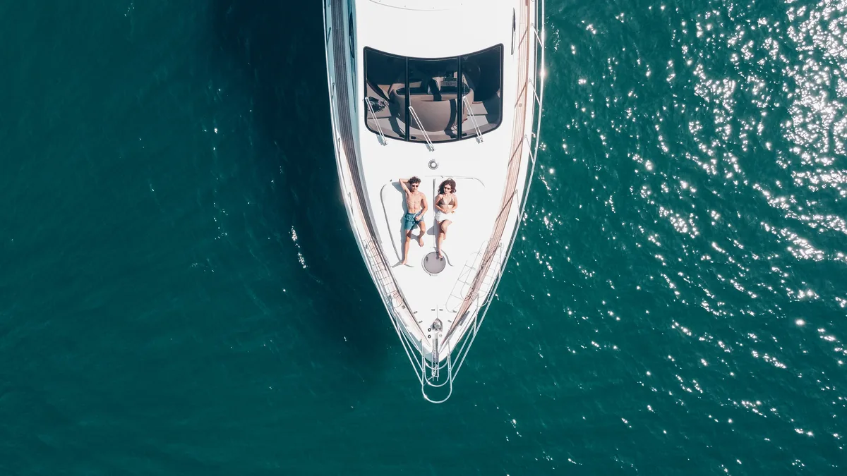 Azimut 55 After 8 — overhead aerial view with guests on the bow
