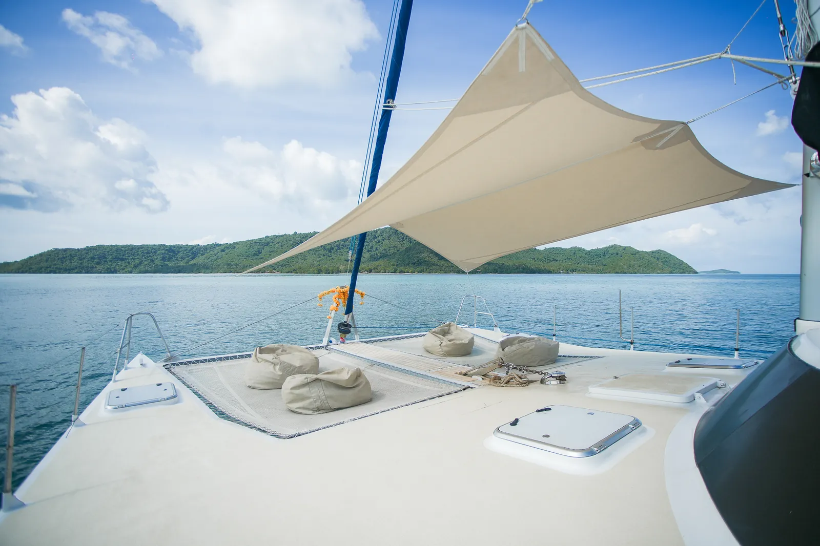 Foredeck and trampolines of sailing catamaran Amadeus at anchor in the Andaman Sea