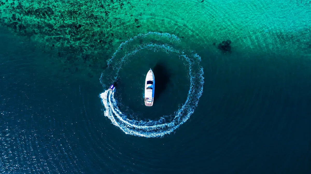 Riva 70 Aria Blue — overhead aerial view turning in clear water