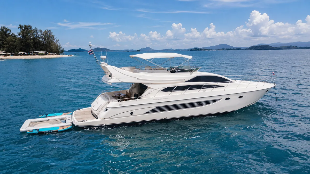 Riva 70 Aria Blue — profile view at anchor beside an island
