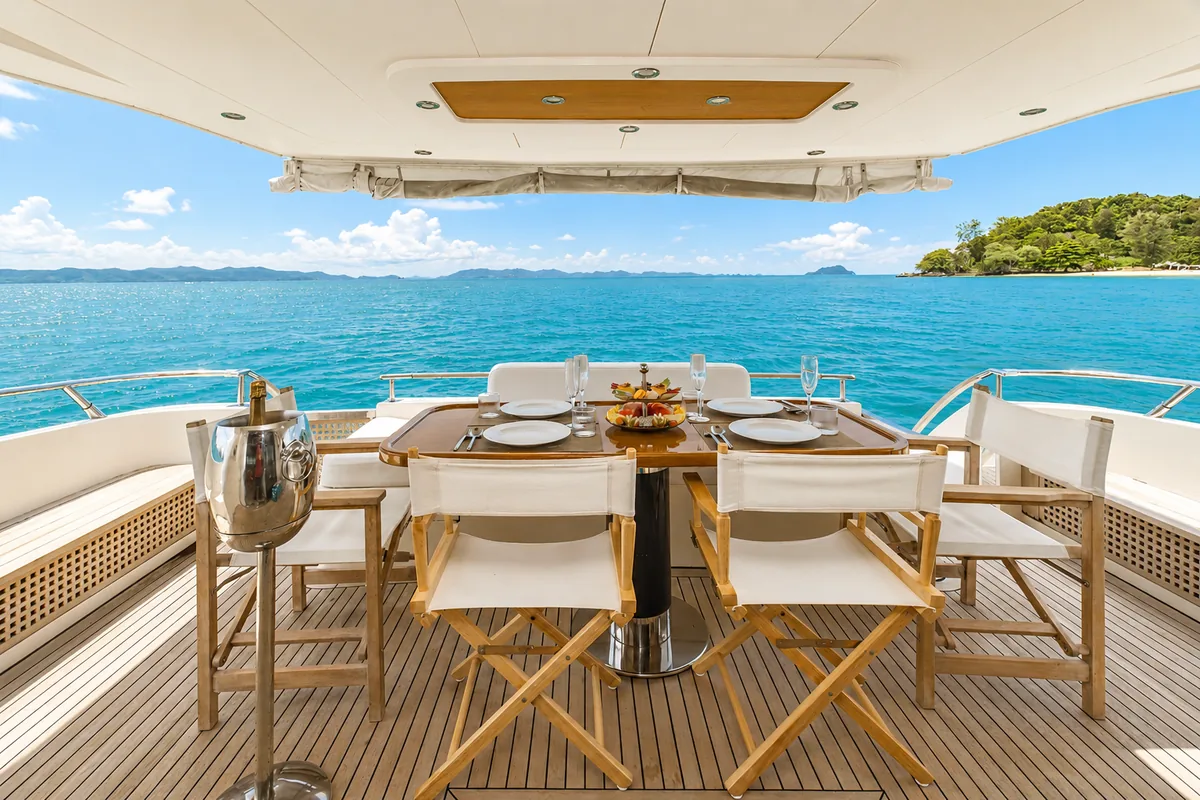 Riva 70 Aria Blue — aft deck dining table set for guests