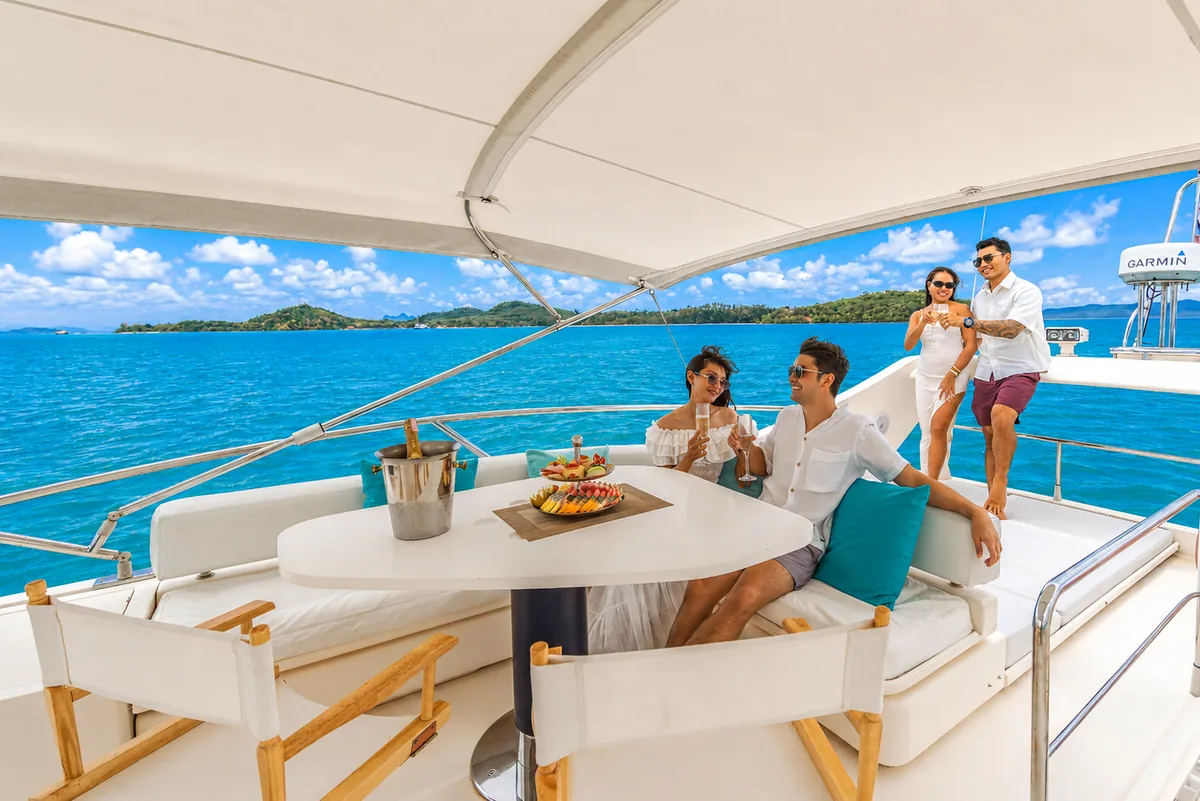 Riva 70 Aria Blue — flybridge seating with guests under way