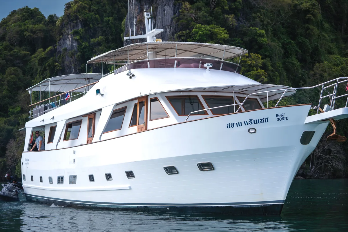 Siam Princess 70 — broadside profile view with karst scenery behind