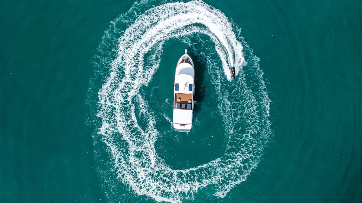 Siam Princess 70 — overhead aerial view turning in open water